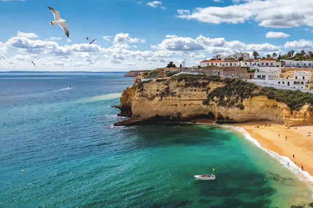 Carvoeiro village beach in the Algarve with cliff and traditional houses