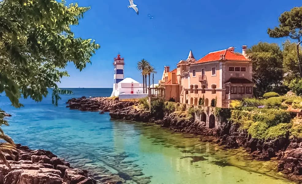 Santa Marta Lighthouse in Cascais with rocky coastline and blue Atlantic views, Portugal