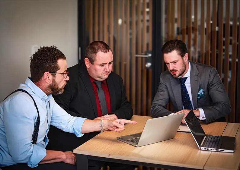 Professional business discussion between colleagues in a private meeting room