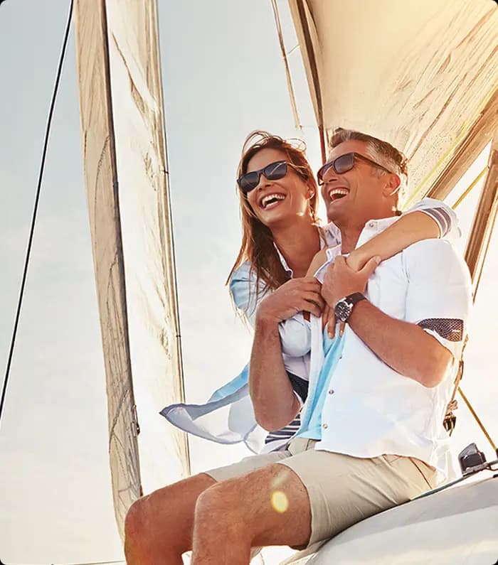 A senior couple having fun on top of a yacht